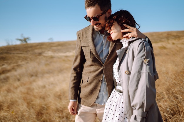 Young couple walks in the park during the spring and hugs Enjoying time together