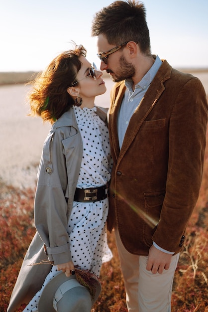 Young couple walks in the park during the spring and hugs Enjoying time together