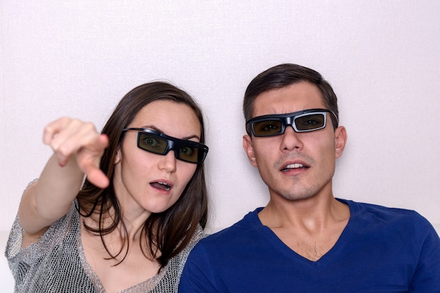 Young couple watching movie in 3D glasses, closeup portrait