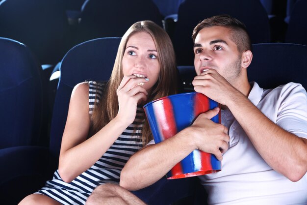 Young couple watching movie in cinema