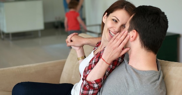 Young couple watching tv in the living roonm