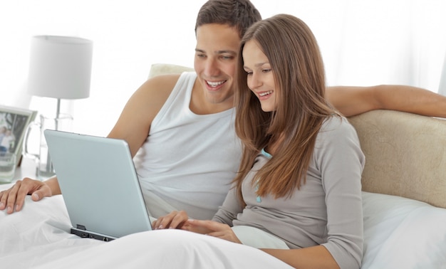 Young couple watching a video on the laptop