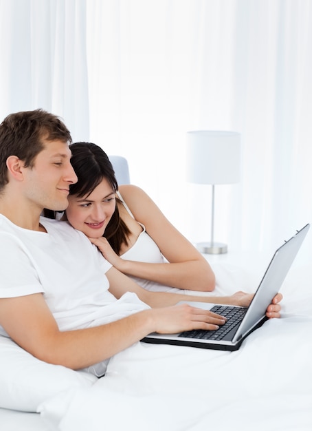 Young couple watching videos on their computer at home