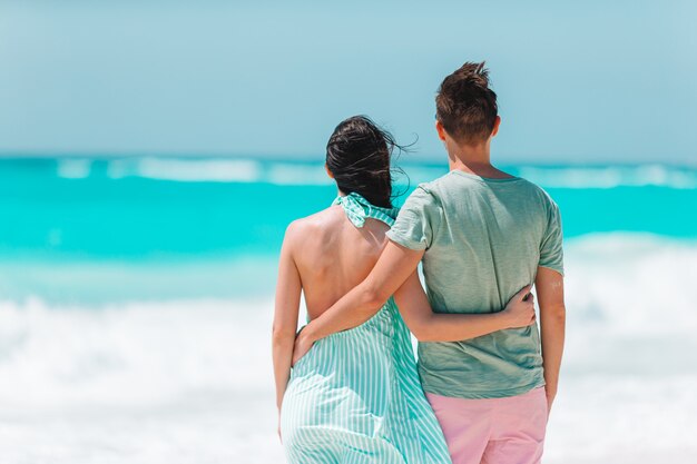 Young couple on white beach during summer vacation.