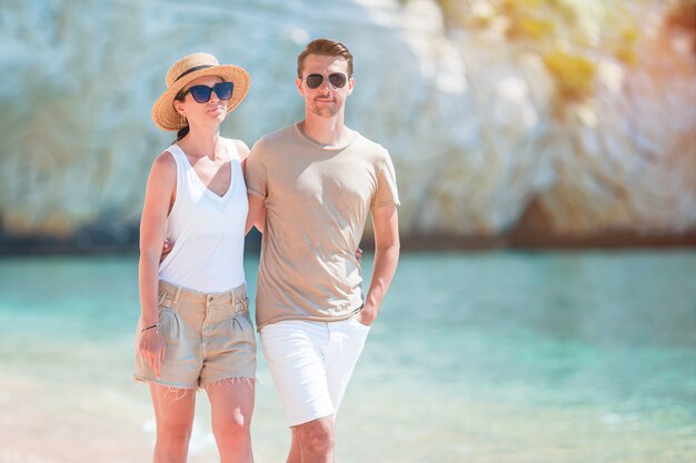 Young couple on white beach at summer vacation