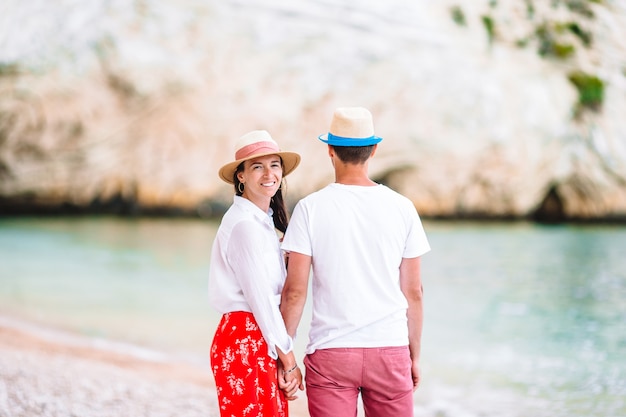 Young couple on white beach during summer vacation.