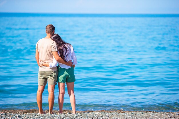 Young couple on white beach during summer vacation.