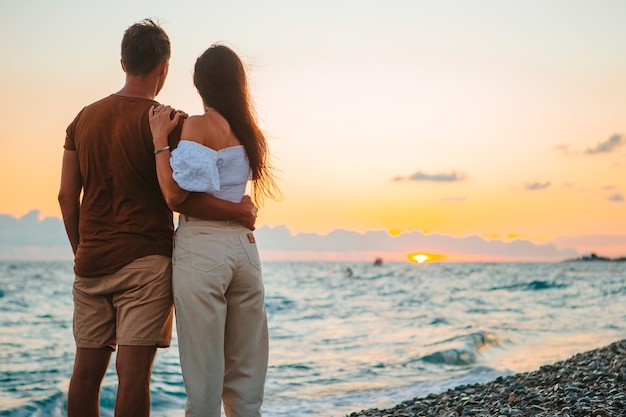 Young couple on white beach during summer vacation