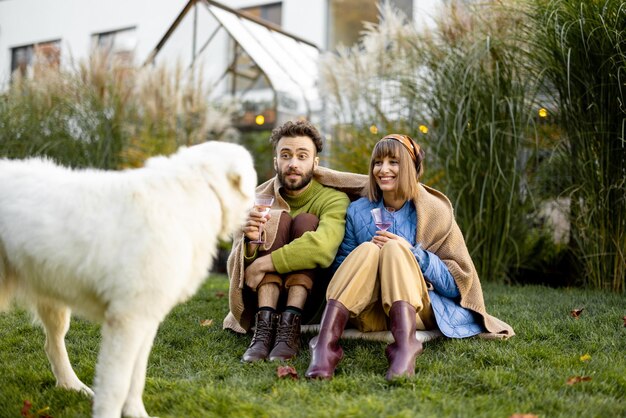 Young couple with dog at backyard