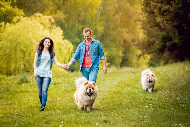 Young couple with the dogs in the park