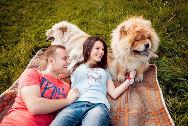 Young couple with the dogs in the park