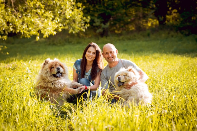 Young couple with the dogs in the park