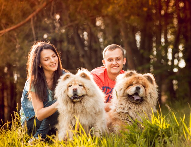 Young couple with the dogs in the park