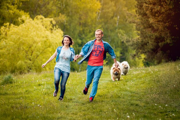 Young couple with the dogs in the park