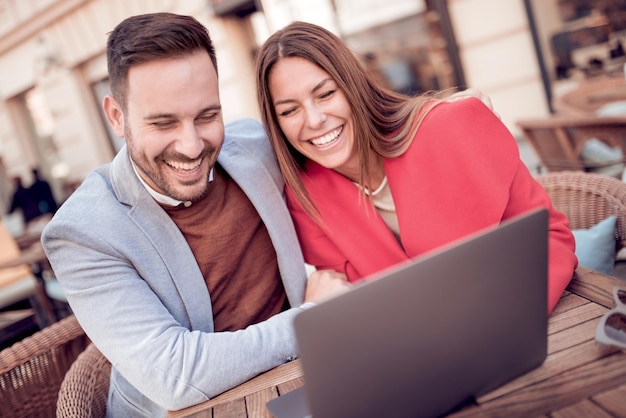 Young couple with laptop in cafe