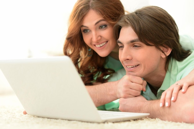 young couple with laptop at home