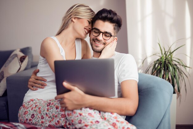 Young couple with laptop in the living room