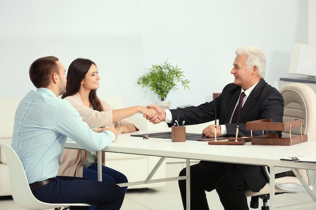 Young couple with notary at office