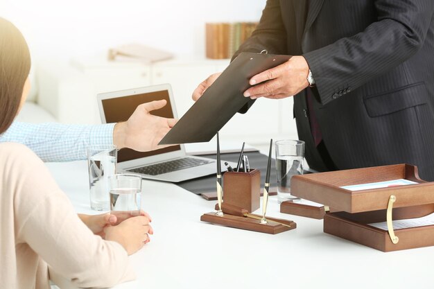 Young couple with notary at office