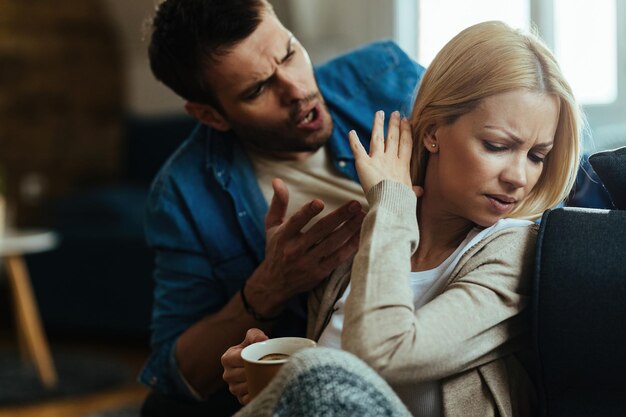 Young couple with relationship difficulties arguing about their problems at home