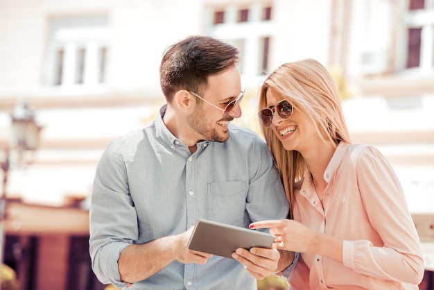 Young couple with tablet on the street