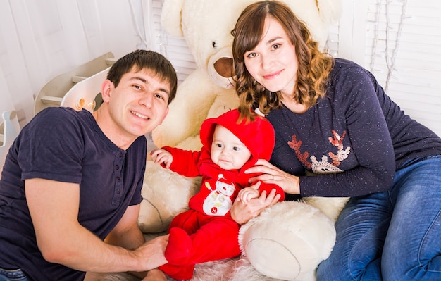 Young couple with their newborn baby indoors