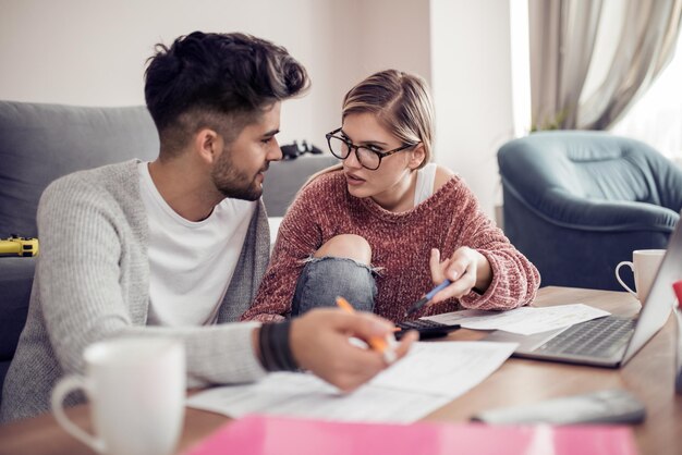 Young couple working together at home