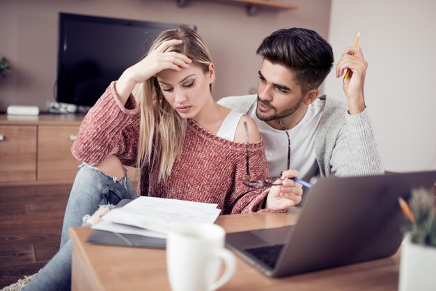 Young couple working together at home