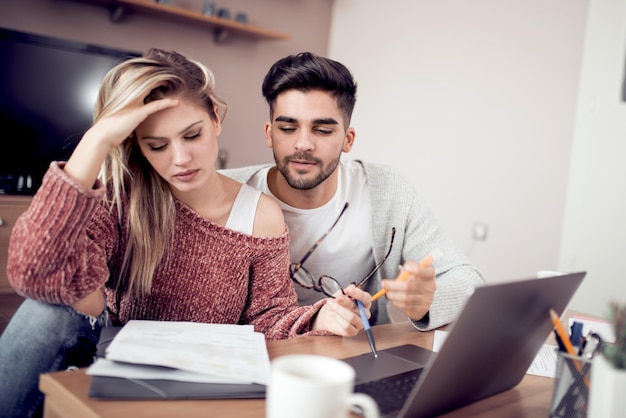 Young couple working together at home