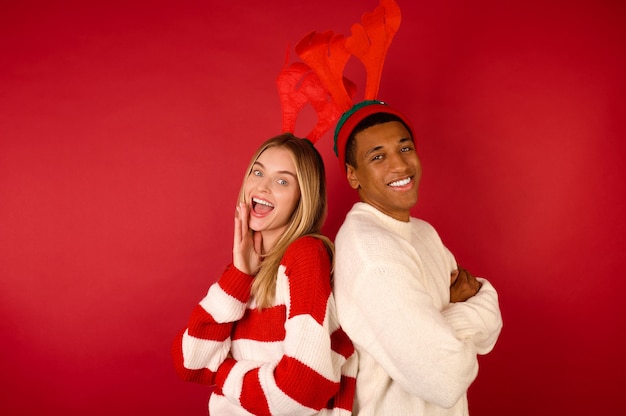 A young couple in Xmas clothing looking enjoyed