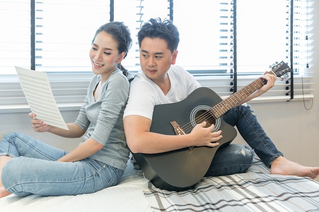 Young Couples playing guitar