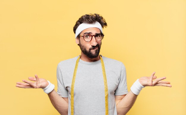 Young crazy bearded athlete doubting or uncertain expression