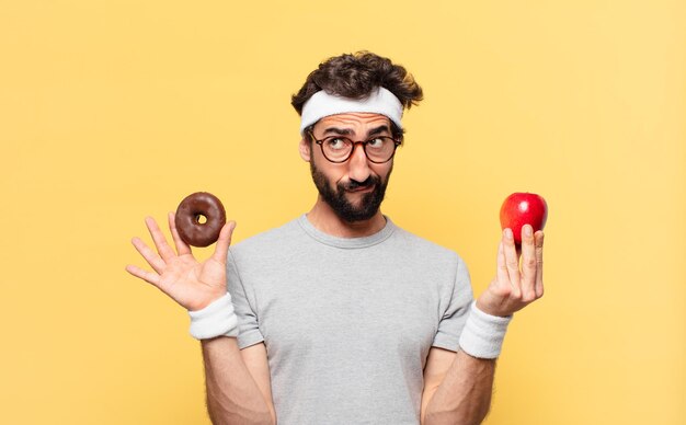 Young crazy bearded athlete doubting or uncertain expression