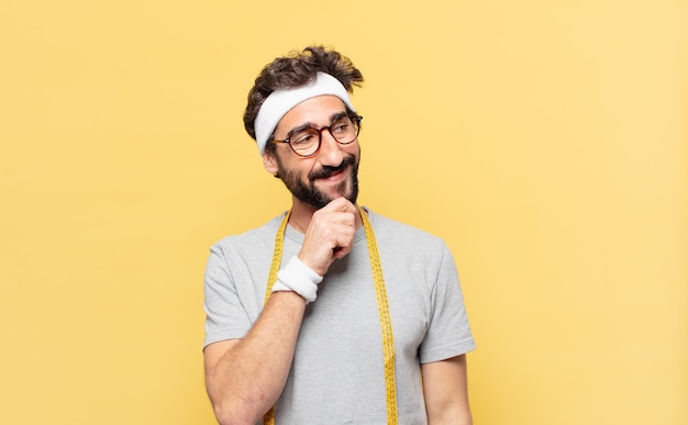 Young crazy bearded athlete with thinking expression