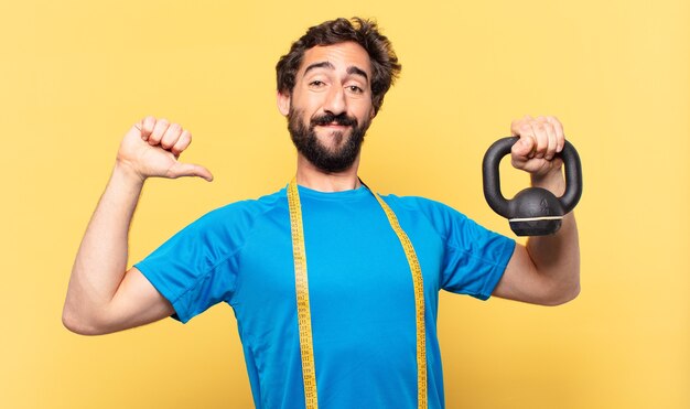 Young crazy bearded athlete young crazy bearded athlete happy expression and lifting a dumbbell