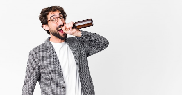 Young crazy bearded businessman having a beer