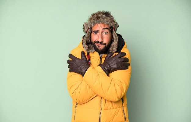 Young crazy bearded and expressive man cold and winter concept and wearing an anorak