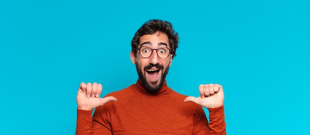 Young crazy bearded man. celebrating a triumph like a winner