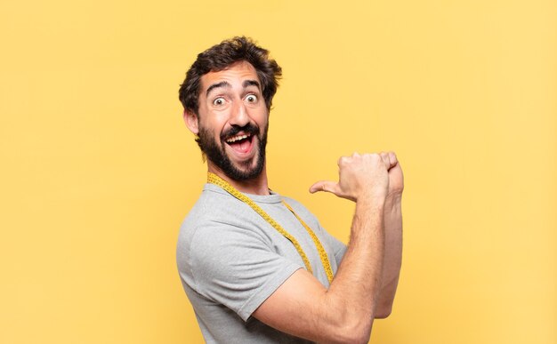 Young crazy bearded man dieting happy expression