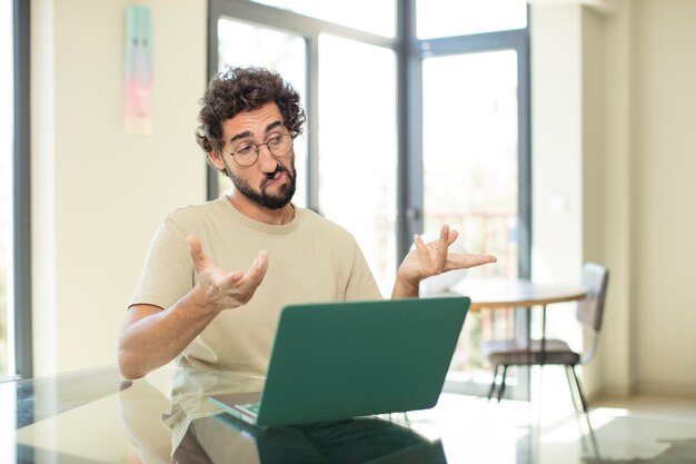 young crazy bearded man expressing a concept