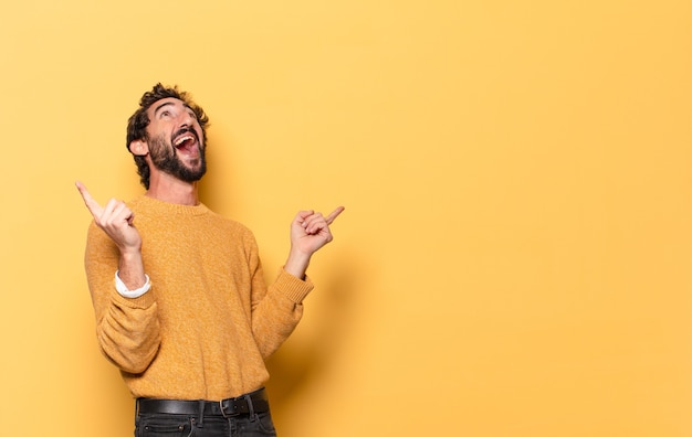 Young crazy bearded man expressing with a copy space.