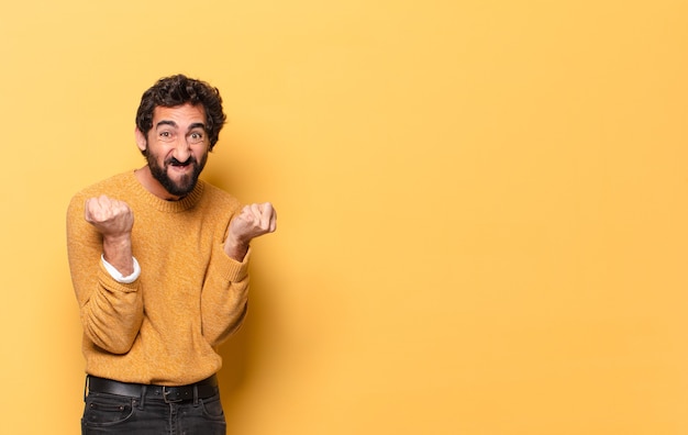 Young crazy bearded man expressing with a copy space.