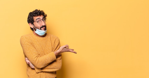 Young crazy bearded man expressing with a copy space