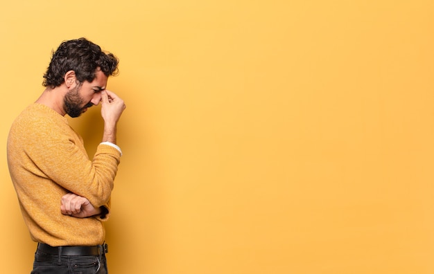 Young crazy bearded man expressing with a copy space.