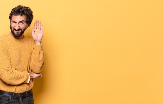 Young crazy bearded man expressing with a copy space.