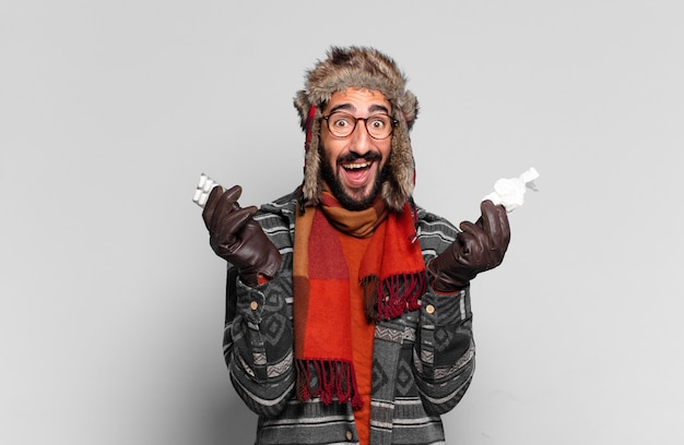 Young crazy bearded man. happy and surprised exssion and wearing winter clothes. illness concept