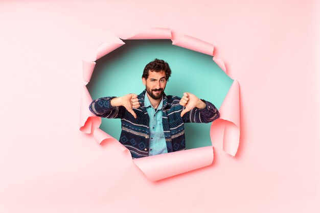 Young crazy bearded man. paper hole empty background concept