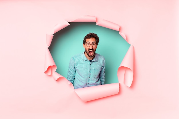 Young crazy bearded man. paper hole empty background concept