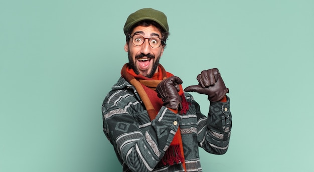 Young crazy bearded man proud expression and wearing winter clothes