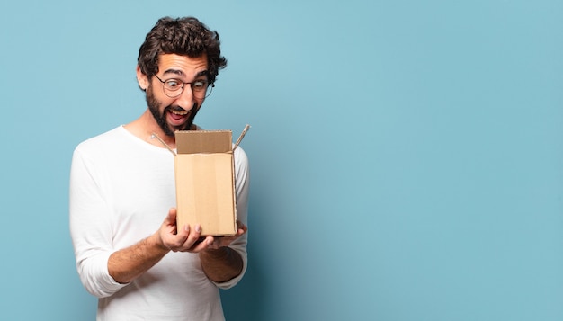 Young crazy bearded man recibing a cardboard package